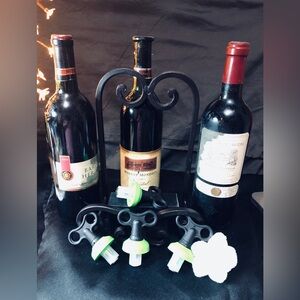 Set of Four Black Metal Wine Bottle Stoppers.